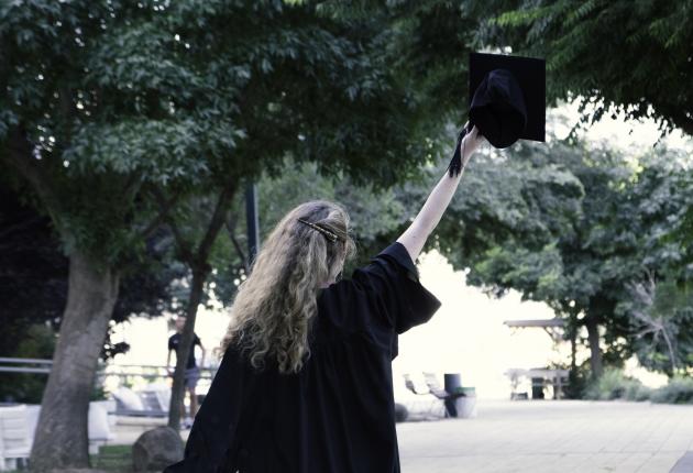 Woman holding up cap